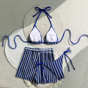 Detailed flat lay of three-piece navy striped bikini set with high waist shorts