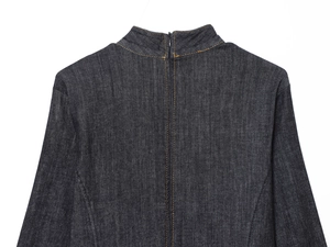 Détail d'une robe courte en jean foncé avec surpiqûres contrastées et fermeture éclair au dos
