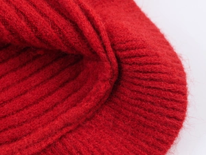 Close-up of bright red heavy-knit fabric showing detailed vertical ribbed texture
