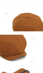 Detail of caramel brown newsboy cap showing twill texture and adjustable elastic band