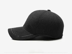 Detail of dark grey winter baseball cap showing knitted texture and Sport embroidery