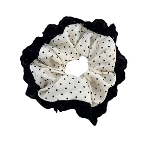 Vintage layered scrunchie with black lace trim and white polka dot fabric on white background