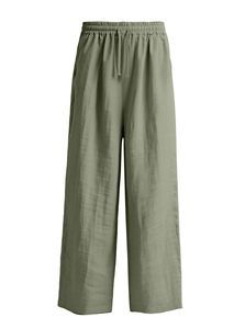 Detail view of elastic waist and drawstring on olive green linen trousers