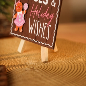 Macro shot of wooden gingerbread man sign with Holiday WISHES text for Christmas decor