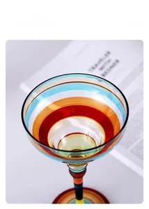 Detailed macro view of multi-colored hand-painted stripes on glass cocktail margarita cup