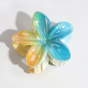Macro detail of lily flower hair claw featuring iridescent laser gradient and white teeth
