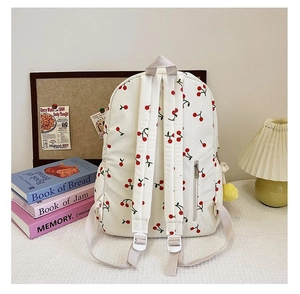 Rear view of corduroy cherry backpack featuring adjustable straps and anti-theft zip pocket