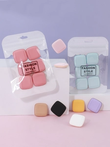 Detailed view of colorful square finger powder puffs in transparent zippered pouch