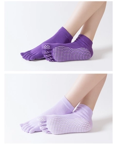 Detail of non-slip silicone grips on purple open-back five-toe yoga socks for women