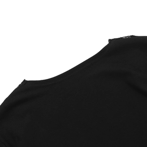 Close-up of deep V-neckline with delicate lace trim on black knitted long sleeve top
