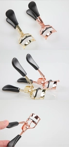 Macro detail of portable stainless steel eyelash curlers with black silicone padding