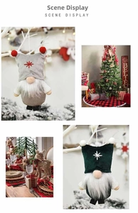 Festive plush faceless gnome ornaments in gray and green on a decorated Christmas tree