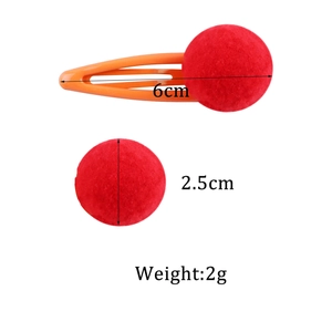 Plush red ball hair clip for girls with a 6cm length measurement on white background