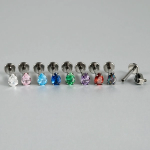 Detail showing G23 titanium flat back stud with internal thread and teardrop zircon