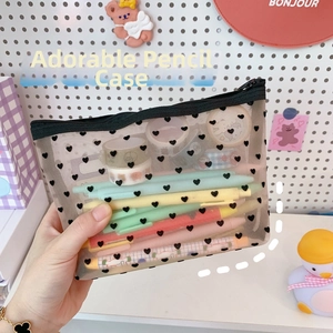 Close-up of heart print mesh cosmetic bag showing stationery capacity and transparency