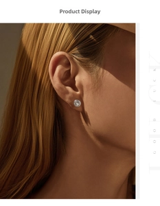 Close-up of a halo moissanite earring featuring a brilliant-cut center stone on a model