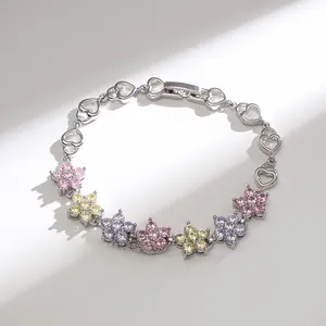 Macro shot of snowflake bracelet with multi-colored AAA zircon flower petals and heart chain