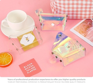 Detail of laser holographic and transparent PVC mini pouches with metal snap button closures