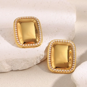 Luxury 18K gold plated rectangular pearl earrings displayed on a white stone base