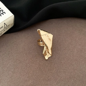 Detailed view of the gold irregular geometric folded metal ring with glossy finish