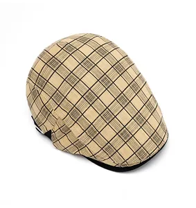 Top down view of beige and black plaid newsboy cap showing fine cotton texture