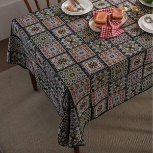 Close-up of bohemian jacquard tablecloth featuring vintage colorful geometric square patterns