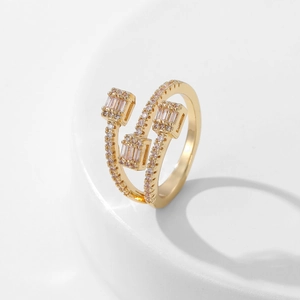 Macro detail of triple-layer gold ring with micro-paved zircons and rectangle stones