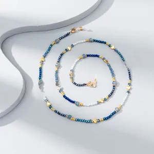 Macro detail of multicolored crystal beaded eyewear chain with golden heart charms
