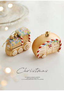 Close-up of golden Christmas train and camper ornaments with colorful festive beads
