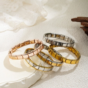 Detail of adjustable stainless steel modular link bracelets in gold and silver finish