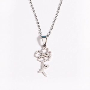 Detail of silver stainless steel necklace with delicate cutout flower petal pendant