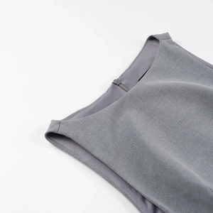 Detail of high-quality grey sleeveless dress fabric featuring a seamless hidden zipper