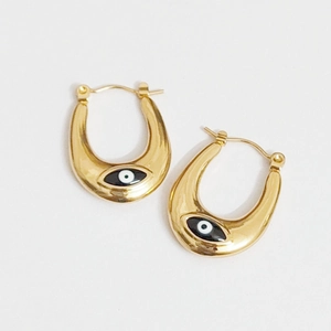 Gold U-shaped evil eye earrings with black enamel accents on white background