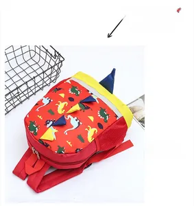 Close-up of red dinosaur backpack featuring adjustable straps and mesh side pockets