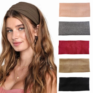 Close-up of ribbed knit elastic headbands in six solid colors for sports and fitness