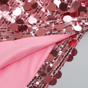 Detailed macro view of pink sequins and mesh fabric on a stylish A-line cocktail dress