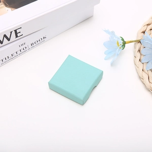 Detailed view of mint green textured jewelry gift box set in a stylish lifestyle setting