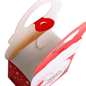 Macro shot of red and white Christmas gift box handle with Happy Christmas text
