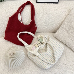 Detail of plush tote bags showing soft knit texture and interior lining pocket
