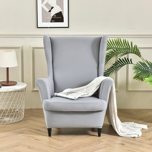 Stretch wingback chair cover in grey fabric for a cozy modern living room setup