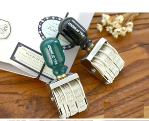 Detail of vintage wooden date stamps with roller knobs on a rustic desktop