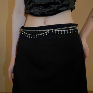 Detail of silver double-layered waist chain with sparkling rhinestones and tassels