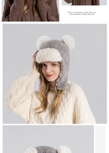 Close-up of winter plush trapper hat with white pom-poms and warm faux fur lining