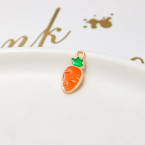 Macro shot of carrot-shaped gold enamel pendant for DIY necklaces and jewelry