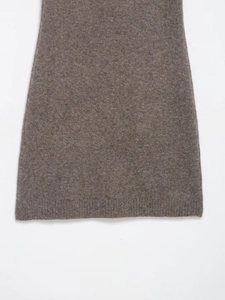 Close-up of soft ribbed hem on a brown knitted mini dress showing fabric texture