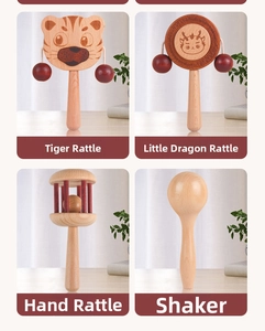 Detail of wooden baby rattle set including tiger and dragon rattles on a wooden desk