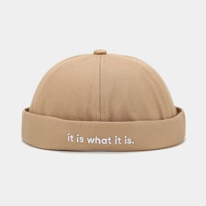 Detailed close-up of khaki docker hat showing white embroidery on thick cotton fabric