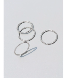 Set of four minimalist silver beaded rings with a polished stackable finish and micro-grain texture