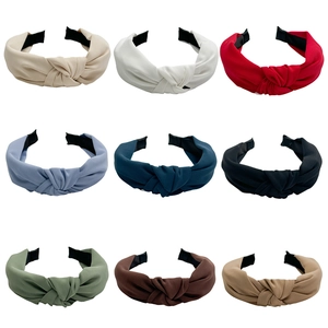 Set of nine colorful knotted fabric headbands in assorted basic and trendy summer colors