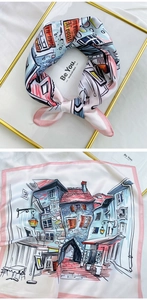 Close-up of square silk scarf with European town illustration and soft satin finish